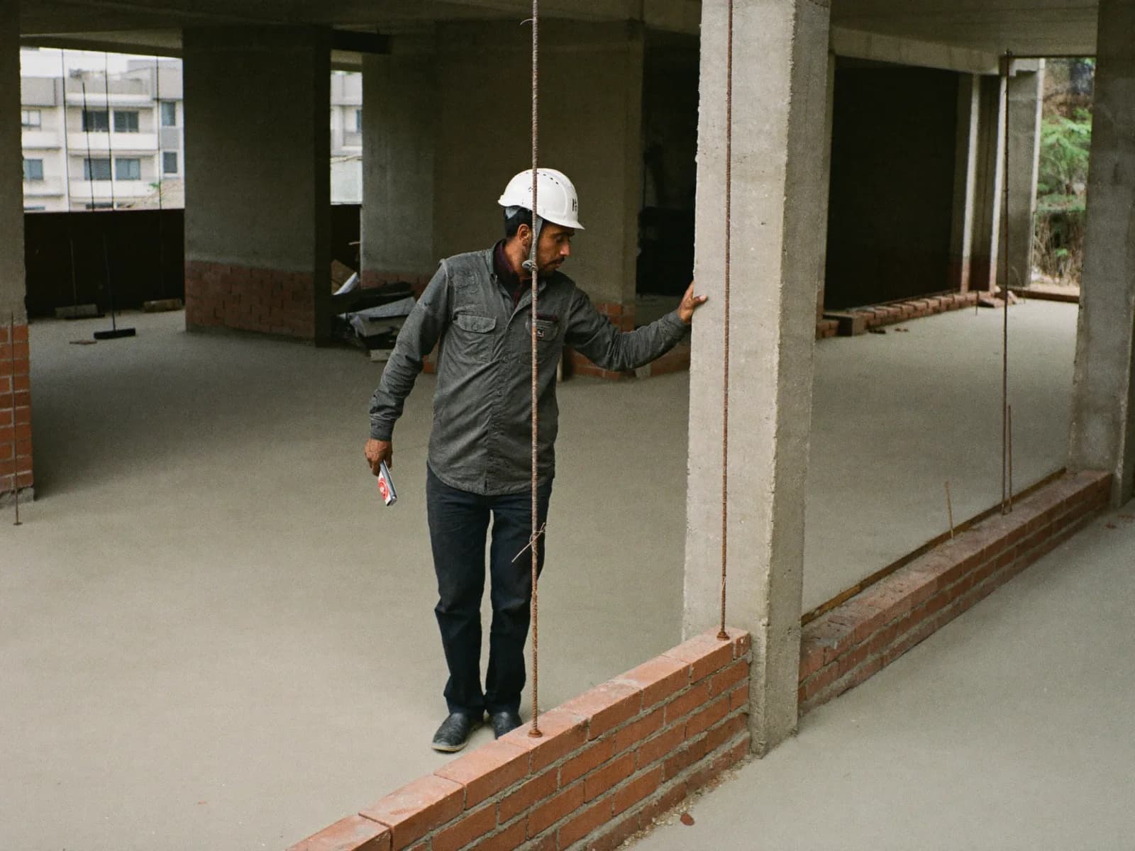 A site supervisor checking work on an unfinished floor